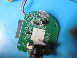 Printed Circuit Board with Electronic Components A printed circuit board with electronic components, including a microphone, connectors, and ICs.