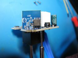 Smart Plug with BL0937 Measuring Circuit Smart plug with visible measuring circuit on a blue workbench background.