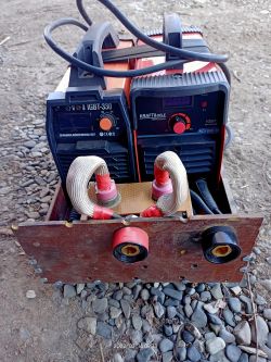 Two inverter power sources IGBT side by side, with different labels on the front panels.