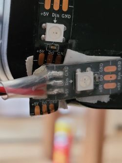 LED strip segment with visible +5V, Din, GND labels and diodes.