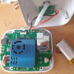 Open casing of an electronic device showing a battery module and circuit board.