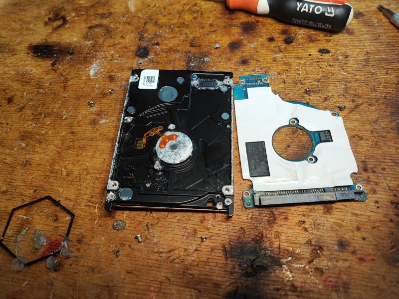 Disassembled HDD Disassembled HDD on a wooden table.