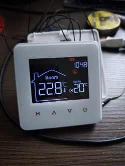 Room thermostat with display showing 22.8°C current and 20°C set temperature