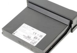 Black electronic box with a white label showing markings and a QR code.