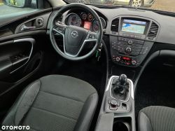 Interior of an Opel Insignia car showing the dashboard, steering wheel, and multimedia panel.