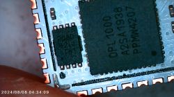 Close-up of an electronic circuit with two visible chips on a circuit board.