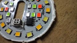 Close-up of a round circuit board with LEDs in various colors.