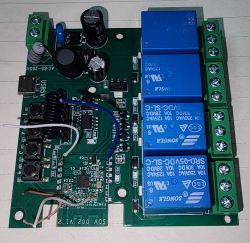 Electronic circuit board with blue relays and various components.