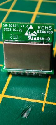 SM-028C3 module with ESP32-C3 chip on a green PCB with markings.