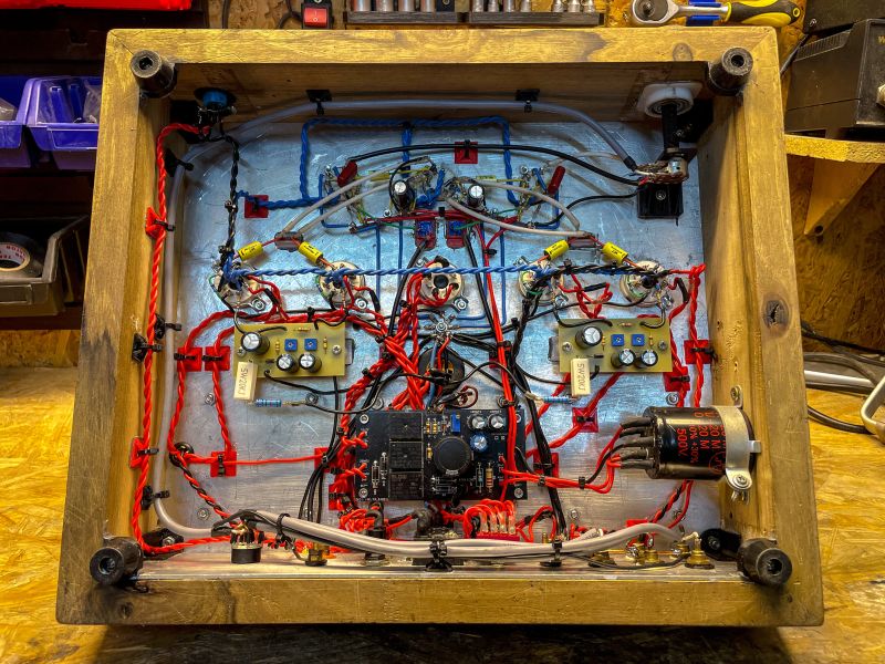 Interior of Tube Amplifier Interior of a tube amplifier in a wooden case with red and blue wires.