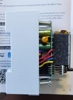 Electronic board inside a device with visible wires and components.