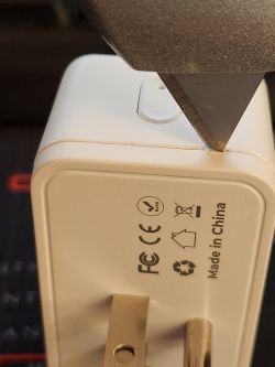 Opening Tuya US Plug with Utility Knife Tuya US electrical plug with a utility knife placed along the seam of the casing.