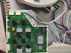Close-up of a circuit board with LED displays, showing electronic components and wires.