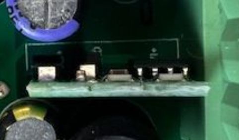 Close-up of electronic components on a green printed circuit board