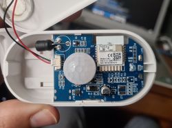 Interior of an alarm device showing a PCB board, sensor, and electronic module.