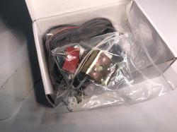 ATLO-GDC2-TUYA Garage Door Controller Kit in Box Contents of the ATLO-GDC2-TUYA garage door controller set in an open box, with visible cables and mounting accessories.