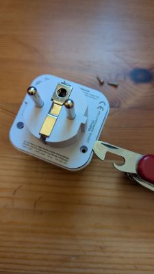 CATA CT-4010 plug with screws removed and a knife used to pry open the case