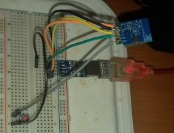 USB-UART adapter connected to a breadboard.