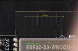 Close-up of an ESP32-S3-WROOM-1 module with black PCB and antenna marking.