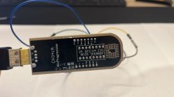 CH341A programmer with visible pin labels on a black PCB.