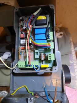 Electronic circuit board inside a control box The inside of an electrical box with a visible electronic circuit board and colorful wires.
