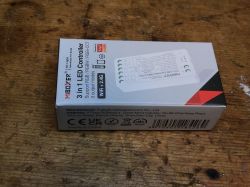 MiBoxer 3 in 1 LED controller packaging on a wooden table