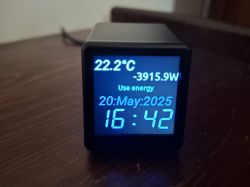 Wi-Fi ESP8266 Display with Weather and Energy Data Small cube with LCD display showing temperature, power, date, and time.