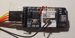 Close-up of a WiFi remote switch module with visible wires and connectors.