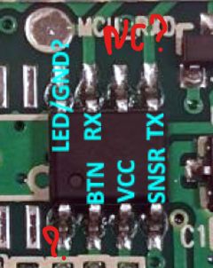 Close-up of an unmarked MCU with pin descriptions on a PCB.