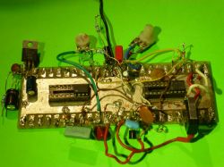 Electronic Circuit Board with Soldered Components Electronic circuit board with soldered components on a green background.