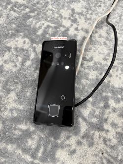Black Tilanco external module on a gray carpet.