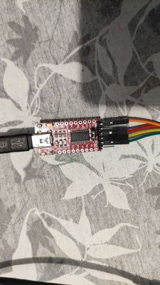 USB to UART converter module with connected wires.