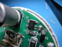 Close-up of a PCB section with SMD components, an IC chip, and a resistor labeled R200