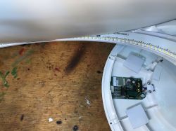 Interior of a ceiling lamp with visible electronic components and LED array in a ring.