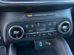 Car climate control panel with temperature display showing 20.0 degrees Celsius.