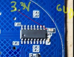 Flipped PCB with marked points for 3.3V and GND.