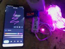 Smartphone with an app for controlling LED lights and a connected meter showing 0.62 A current.