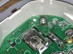 Internal elements of SWP86-01OG socket – PCB fragment Close-up of a power socket PCB showing resistors R11, R12, R13 and metal terminals.