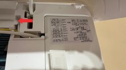 Cable and Wiring Diagram in Della Optima Indoor Unit A red arrow points to a cable above the evaporator coil inside a wall-mounted Della Optima air conditioning unit, next to a wiring diagram label.