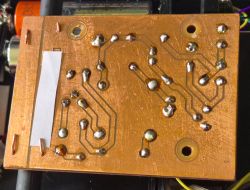 Bottom view of a printed circuit board with soldered joints for an AM radio
