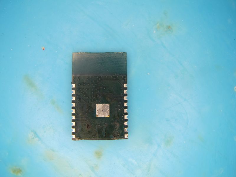 Electronic module with metal shield, placed on a blue background