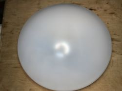 White, round ceiling lamp Woox on a wooden surface