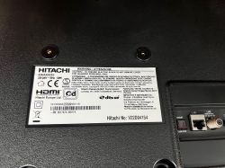 Hitachi TV rating label and rear ports labeled SPDIF, LAN, and LNB on a black back panel.