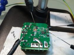 Circuit board with attached probes on a desk.