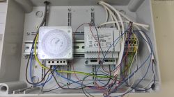 Electrical box with a timer and power supply along with wires.