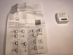 ATLO-SW1-TUYA Relay Module with Installation Guide Small WiFi relay module ATLO-SW1-TUYA next to unfolded Polish installation manual.