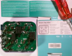 Open casing of KMC Smart Tap Mini showing internal components with a leaflet beside it.