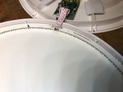 Disassembled ceiling lamp with visible interior and arranged LED lights.