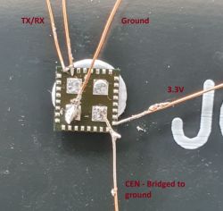 Image of an electronic circuit with connected wires on a board, labeled: TX/RX, Ground, 3.3V, and CEN bridged to ground.