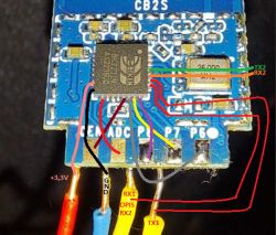 Image of an electronic module with wires labeled in different colors, indicating connections such as +3.3V, GND, RX, and TX.